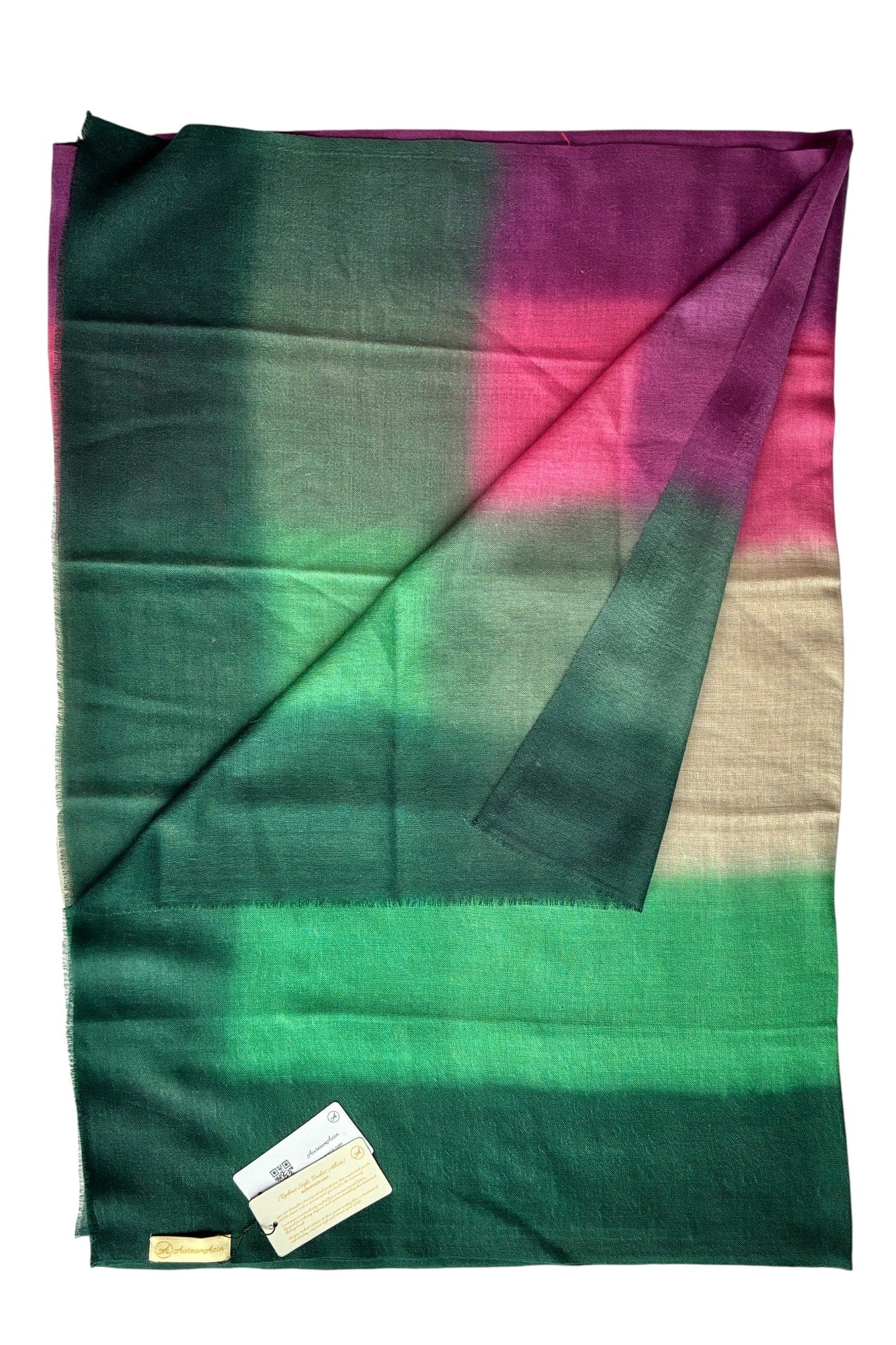 Folded fabric with green and pink gradient on a white background