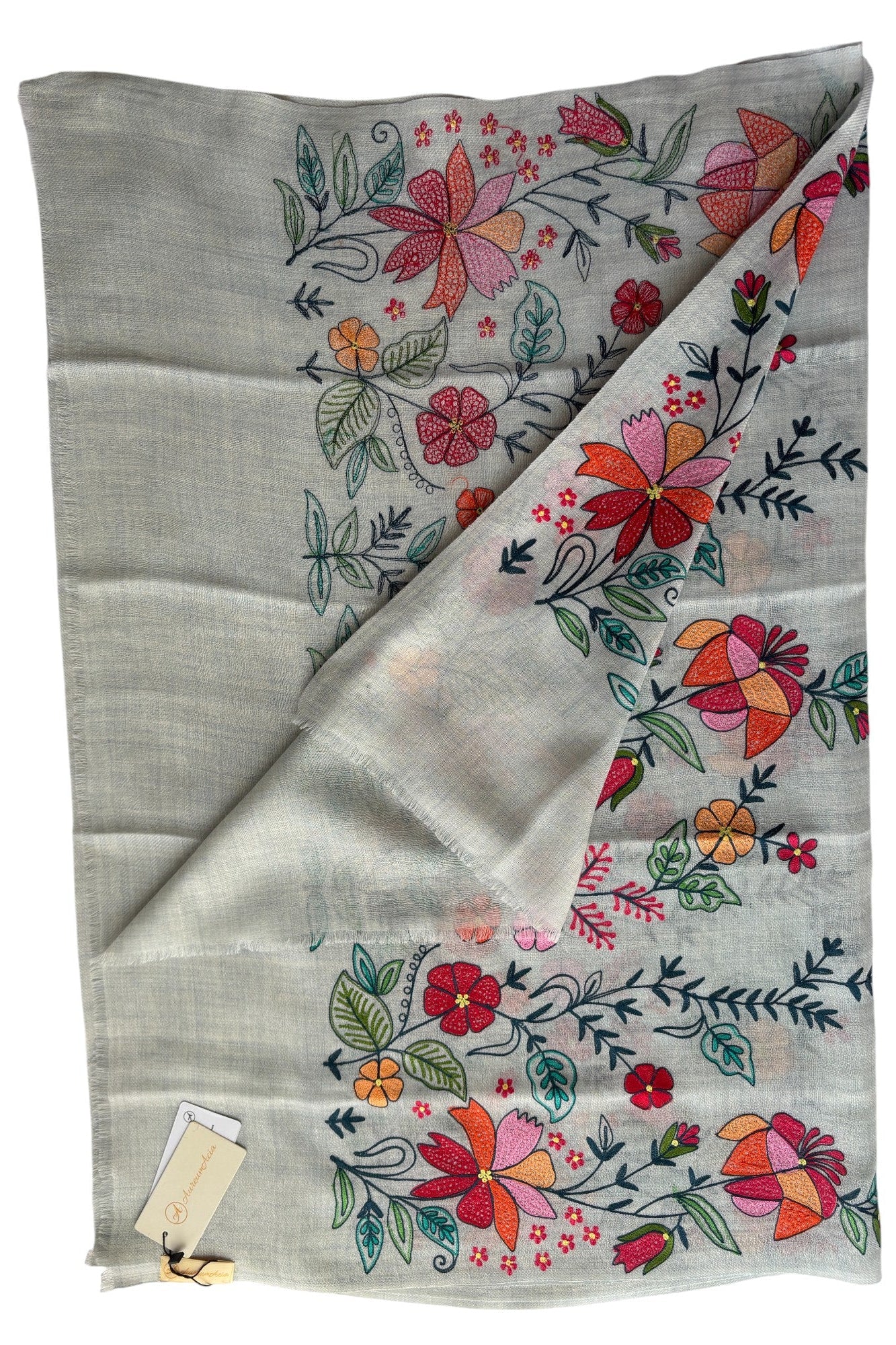 Floral embroidered fabric with colorful flowers on a light gray background