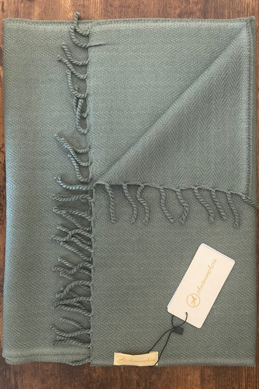 Sage green woollen stole in herringbone pattern with fringes at the end 