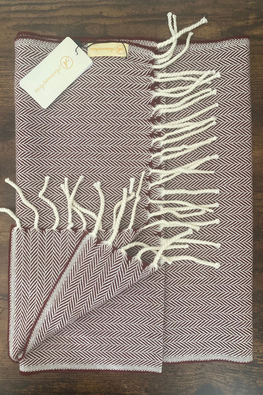 Maroon and white woollen stole in herringbone pattern with fringes at the end 