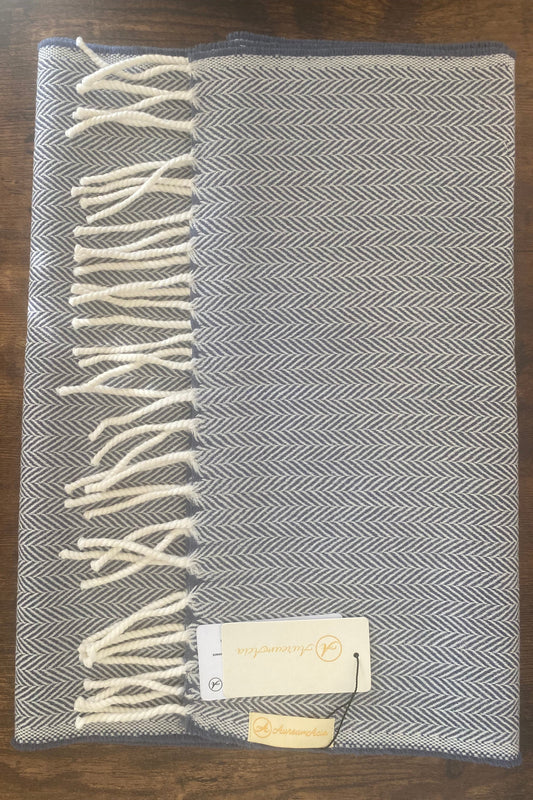 Bluish grey and white woollen stole in herringbone pattern with fringes at the end 