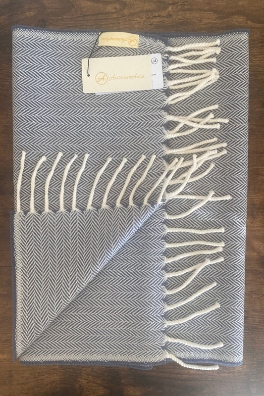 Bluish grey and white woollen stole in herringbone pattern with fringes at the end 