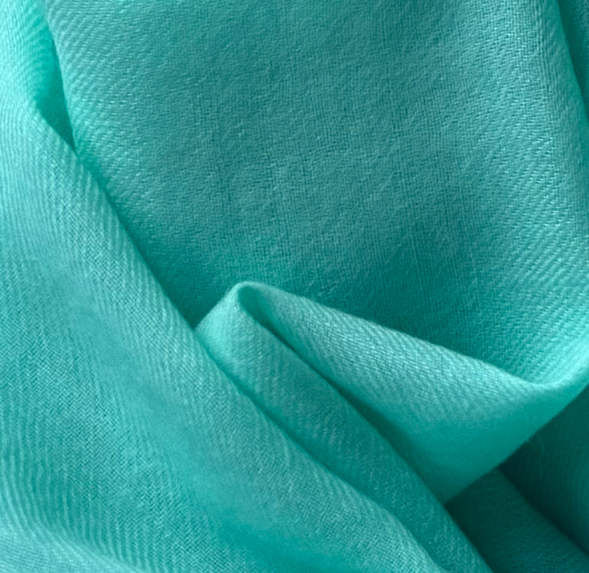 Close-up of teal fabric with cashmere wool