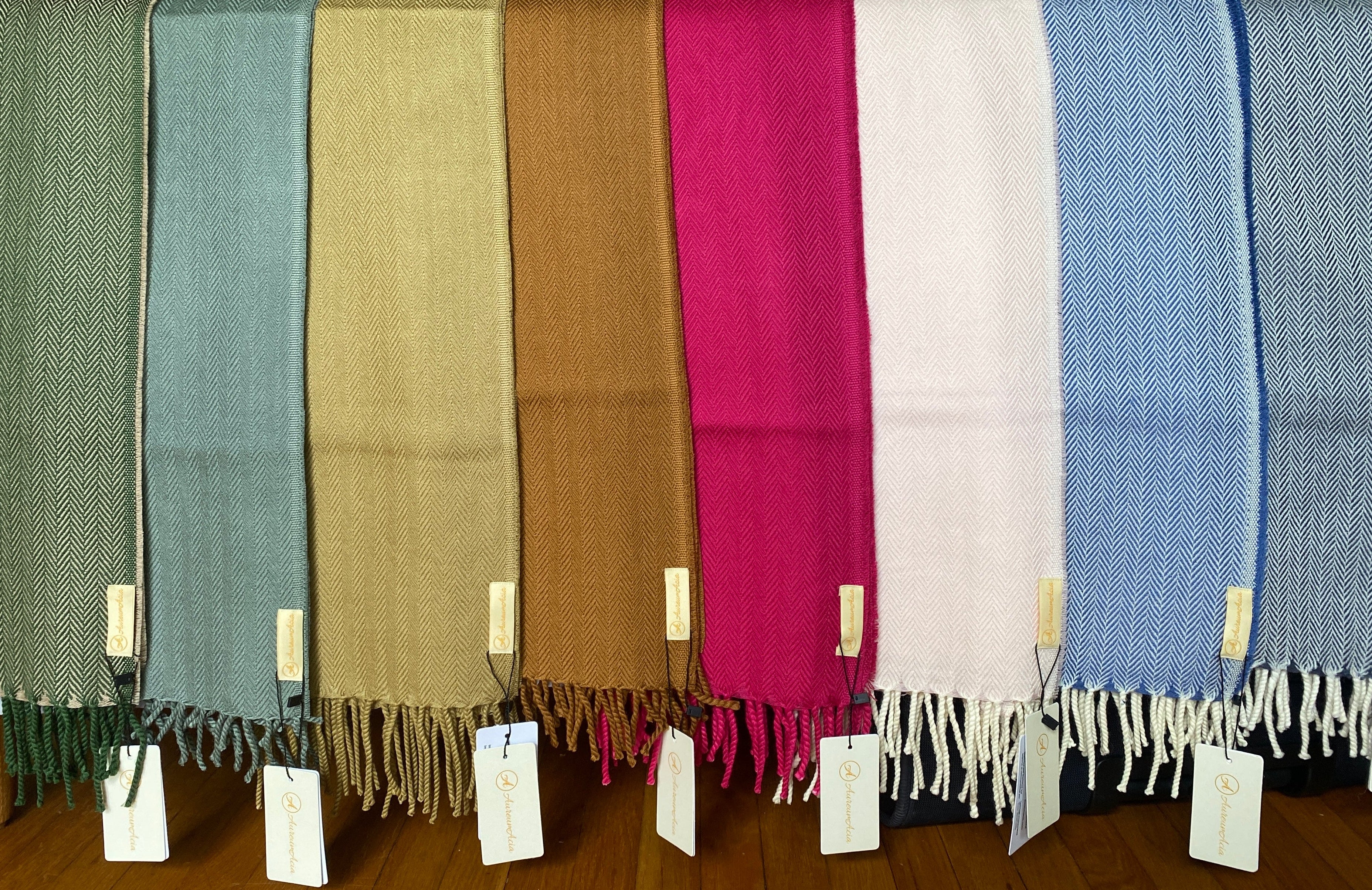 Various stoles in different colours laid side by side.