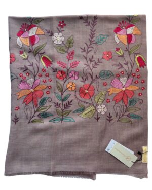 Embroidered floral design on a brown fabric with a tag.