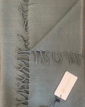 Sage green woollen scarf in herringbone pattern with fringes at the end 