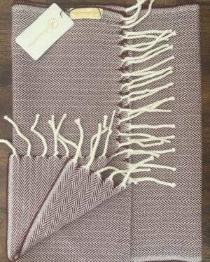 Maroon and white woollen scarf in herringbone pattern with fringes at the end 