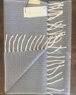 Bluish grey and white woollen scarf in herringbone pattern with fringes at the end 